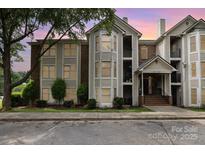 Charming condo building featuring beautiful architecture, landscaping and staircase at 6203 Rosecroft Dr, Charlotte, NC 28215