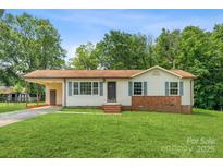Charming single story home featuring brick accents, light siding, and a convenient carport at 798 Wilson St, China Grove, NC 28023
