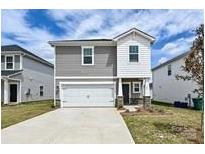 Charming two-story home featuring a front-facing garage, manicured lawn, and inviting entrance at 804 Blue Canyon Dr, York, SC 29745