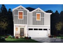 Inviting two-story home featuring a two-car garage, gray siding, and lush landscaping at 804 Blue Canyon Dr, York, SC 29745
