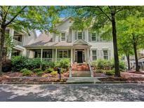 Charming home featuring a welcoming front porch, landscaped garden, and classic architectural details at 104 Edgewater Park St, Davidson, NC 28036