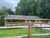 Charming single-story brick home with inviting front porch and wooden railing at 10672 Barberville Rd, Fort Mill, SC 29707