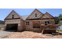 New construction home featuring a brick exterior and an attached two-car garage at 1143 Journey Ln, Salisbury, NC 28146