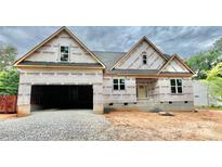 New construction home with a two-car garage and covered entryway, awaiting its finishing touches at 1143 Journey Ln, Salisbury, NC 28146