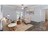 Bright living room featuring hardwood floors, ceiling fan, and neutral color scheme at 11911 Ridgeway Park Dr, Charlotte, NC 28277