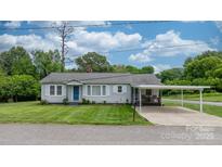 Charming single-story home with a well-manicured lawn and inviting carport at 1266 18Th Ne St, Hickory, NC 28601