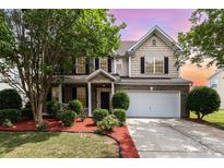 Charming two-story home featuring manicured landscaping and a two-car garage at 13305 Mallard Landing Rd, Charlotte, NC 28278