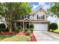 Charming two-story home featuring a brick facade, well-manicured lawn, and a two-car garage at 13305 Mallard Landing Rd, Charlotte, NC 28278