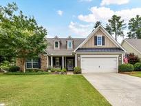 Charming two-story home with a well-manicured lawn, beautiful landscaping, and an attached two-car garage at 200 Sweet Briar Dr, Fort Mill, SC 29707
