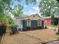Charming single-story home featuring a painted brick facade and well-manicured front yard at 2017 Brewton Dr, Charlotte, NC 28206