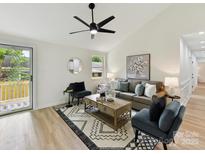 Bright living room with stylish decor, a patterned rug, and an open and airy layout at 2017 Brewton Dr, Charlotte, NC 28206