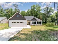 Charming single-story home with white siding, a two-car garage, and a well-maintained lawn at 2705 Enon Church Rd, Salisbury, NC 28147