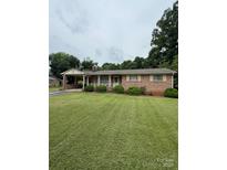 Charming one-story brick home with a well-manicured lawn and a convenient carport at 518 W School St, Maiden, NC 28650