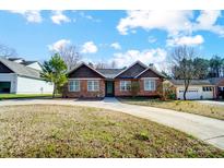 Charming brick home featuring shingled gables and a circular driveway for easy access at 6618 Alexander Rd, Charlotte, NC 28270