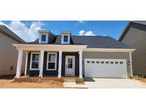Charming single-story home featuring a covered front porch and an attached garage at 725 Sirius Ln # 90, York, SC 29745