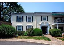 Inviting two-story condo with classic black shutters, well-maintained landscaping, and charming entryway at 8356 Meadow Lakes Dr, Charlotte, NC 28210