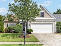 Charming one-story home boasts manicured landscaping, a two-car garage, and classic architectural details at 8603 Robinson Meadow Ct, Charlotte, NC 28277