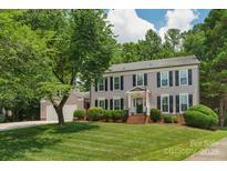 Charming two-story home features a well-manicured lawn, lush landscaping, and inviting curb appeal at 9423 Wood Ridge Dr, Charlotte, NC 28277