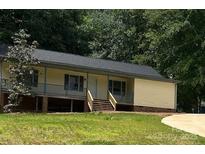Charming single-story home featuring a welcoming front porch and well-maintained yard at 103 Sycamore Rd, Salisbury, NC 28147