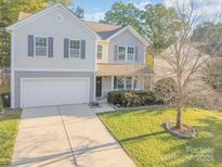 Charming two-story home featuring a well-manicured lawn and a two-car garage at 1219 Century Dr, Clover, SC 29710