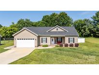 Charming ranch-style home featuring a welcoming front porch, neutral siding, and a well-maintained lawn at 129 Sara Ln, Statesville, NC 28625