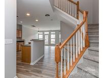 Inviting foyer with hardwood floors, featuring an adjacent staircase and access to the living area at 2169 Belle Vernon Ave, Charlotte, NC 28210
