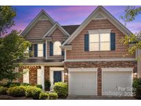 Charming two-story home boasts a manicured lawn, stone accents, and a two-car garage at 2233 Sonoma Valley Dr, Charlotte, NC 28214