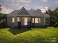 Charming single story home featuring a well-manicured lawn and inviting front porch at 322 Peachtree St, Albemarle, NC 28001