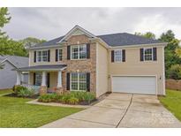 Charming two-story home with a brick and siding facade, manicured lawn and attached two-car garage at 4001 Brook Valley Run, Monroe, NC 28110