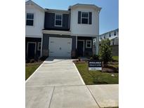 Charming two-story home with a one-car garage and well-maintained front lawn at 4216 Summit Woods Dr, Charlotte, NC 28216