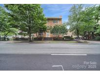 Charming brick apartment building with mature trees and landscaping along a city street at 515 N Church St # 305, Charlotte, NC 28202