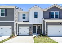 Charming townhouse featuring gray siding, a one-car garage, and a welcoming front entrance at 6110 Starview Ter, Charlotte, NC 28216