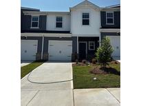 New construction two story townhouse with light gray siding, white trim and white garage door at 6122 Starview Ter, Charlotte, NC 28216