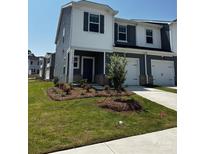 Inviting two-story home featuring a manicured lawn, single car garage, and modern blue and white siding at 6126 Starview Ter, Charlotte, NC 28216