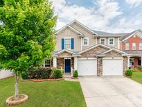 Charming two-story home with a stone facade and a well-manicured front yard at 6532 Prosperity Commons Dr, Charlotte, NC 28269