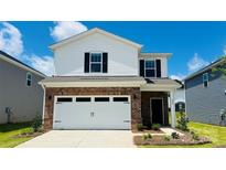 Charming two-story home with white siding, brick accents, a two-car garage, and a well-manicured lawn at 808 Blue Canyon Dr, York, SC 29745