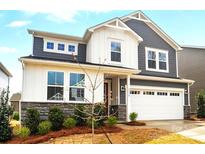 Charming two-story home with blue and white color scheme, stone accents, and a two car garage at 9930 Cask Way, Huntersville, NC 28078