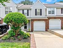 Charming townhome with attached garage, manicured landscaping, and neutral siding for inviting curb appeal at 10063 Reindeer Way Ln, Charlotte, NC 28216