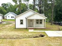 Charming white home with a cozy front porch and well manicured lawn at 1102 Grady St, Salisbury, NC 28144