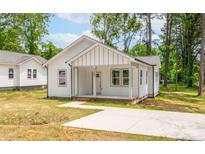 Charming single-Gathering home with a well-manicured lawn and inviting front porch and a concrete driveway at 1102 Grady St, Salisbury, NC 28144
