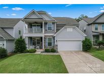 Charming two-story home with a welcoming front porch and attached two-car garage at 1306 San Gabriel Ave, Charlotte, NC 28214
