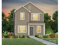 Charming two-story home featuring neutral siding, and a welcoming front yard with manicured landscaping at 14028 Penbury Ln # 331, Charlotte, NC 28278