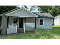 Charming front of house featuring a cozy porch with black posts and white railings at 148 Forest Heights Dr, McAdenville, NC 28101