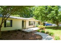 Charming home with manicured landscaping and a welcoming front porch at 155 Springdale Acres Dr, Mooresville, NC 28115