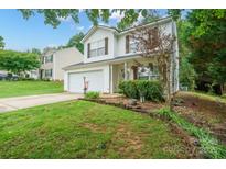 Charming two-story home featuring a well-manicured lawn and attached two car garage at 1912 8Th Se St, Hickory, NC 28602