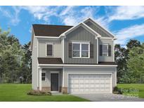 Charming two-story home with gray siding, shutters, a two-car garage and professionally landscaped front yard at 2203 Catawba Trace Dr, Catawba, NC 28609