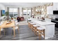 Open concept kitchen and dining area features an island with bar seating and stainless steel appliances at 3095 Big Bend Dr, Kannapolis, NC 28025