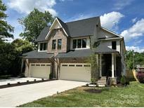 Stunning two-story home featuring a brick and siding exterior, two-car garage, and well-manicured landscaping at 514 W Cama St, Charlotte, NC 28217