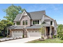 Beautiful new construction home with brick accents, attached two-car garage, and manicured landscaping at 514 W Cama St, Charlotte, NC 28217