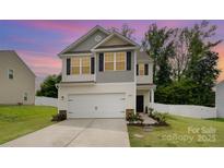 Charming two-story home with a two-car garage, landscaped yard, and a welcoming entrance at 7209 Cuddington Dr, Charlotte, NC 28215